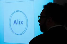 Silhouette d'une personne en avant plan d'un projection où on peut lire Alix.