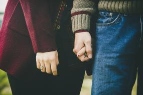 Photographie en gros plan d'un couple qui se tiennent la main.